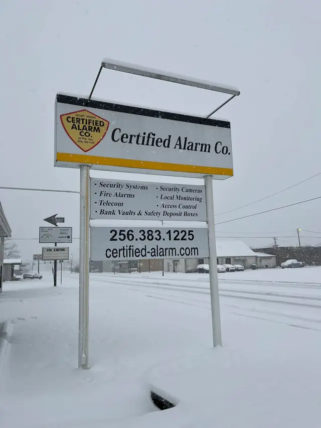 The Certified Alarm Co. roadside sign on North Jackson Highway in the snow